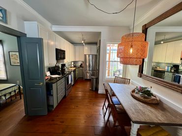 Cozy kitchen and dining area with wooden floors and modern appliances.