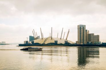 The O2 Arena with a boat on the Thames in London.