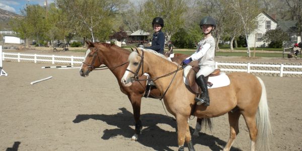 girls riding ponies