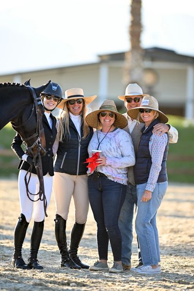 show jumping team smiling at a horse show