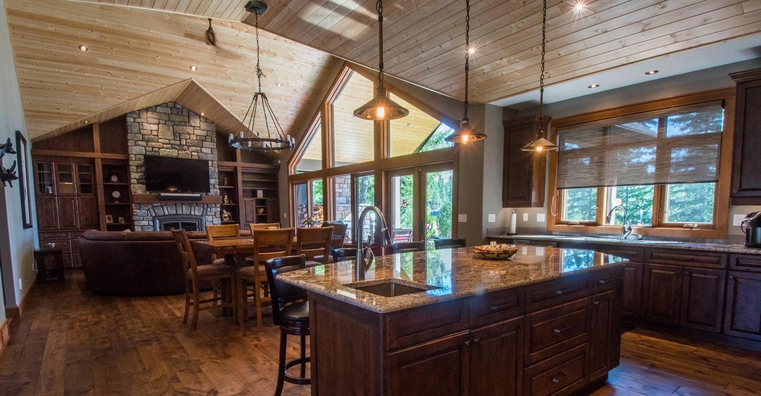 Open plan kitchen and living room with vaulted ceiling.