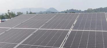 Solar panels installed on a rooftop in a residential area.