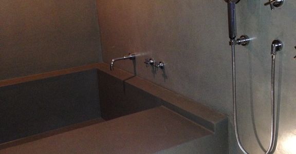 Custom Venetian plaster bathroom showing tub and Handsgrohe fixtures. Nolita.