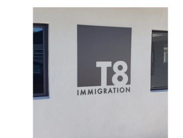 Glossy black acrylic sign with logo cut out