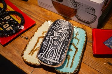 Three decorative ceramic plates with abstract designs on a wooden surface.