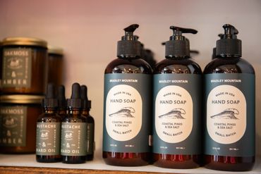Bottles of Bradley Mountain hand soap and beard oil on a shelf.