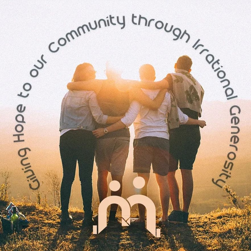 Four friends embracing at sunset, symbolizing community and hope.