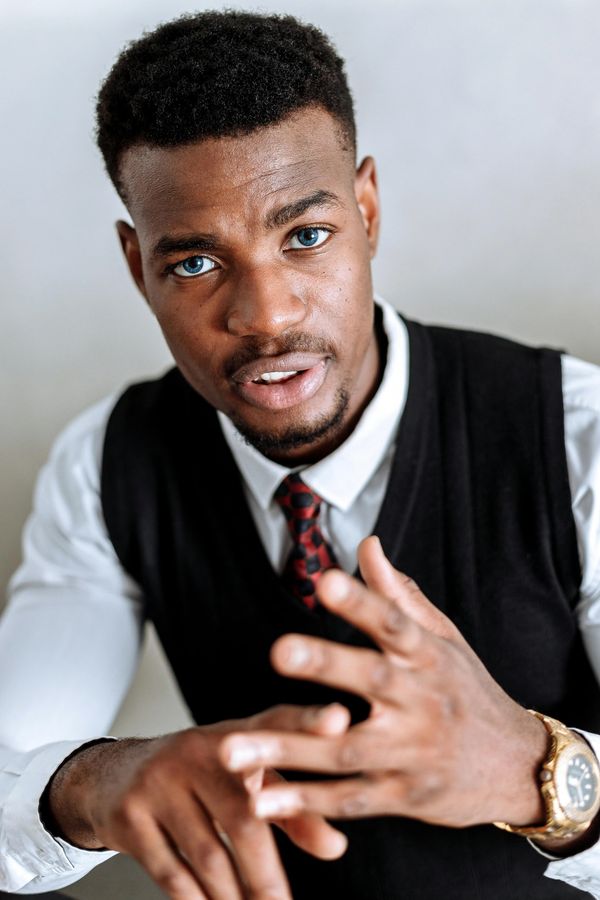 A man stares thoughtfully towards the camera, reflecting on his talents and challenges.