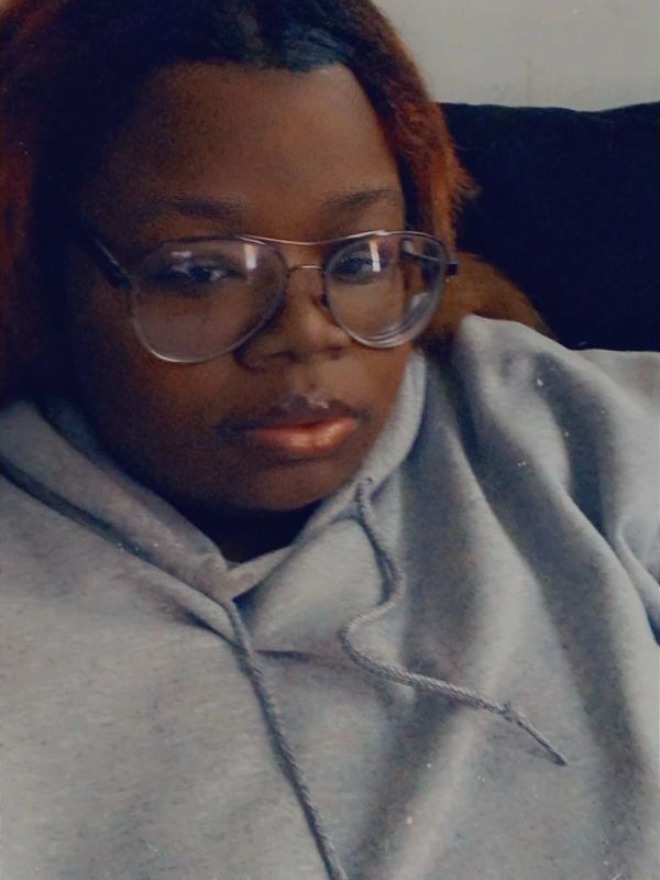 Person wearing glasses and a gray hoodie.