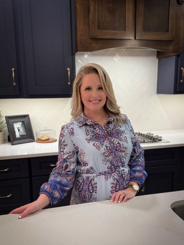 Woman smiling in a stylish kitchen.