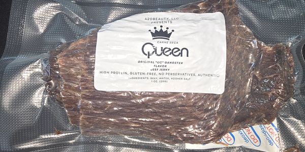 Packaged beef jerky labeled as 'Queen' with no preservatives and high protein.