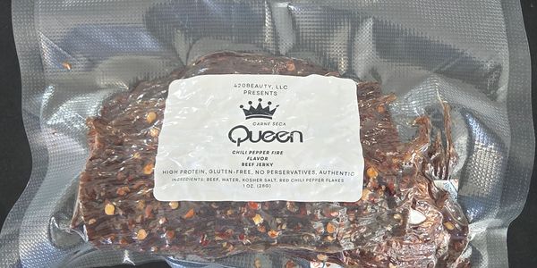 Vacuum-sealed bag of Queen brand chili pepper fire beef jerky with visible chili flakes.