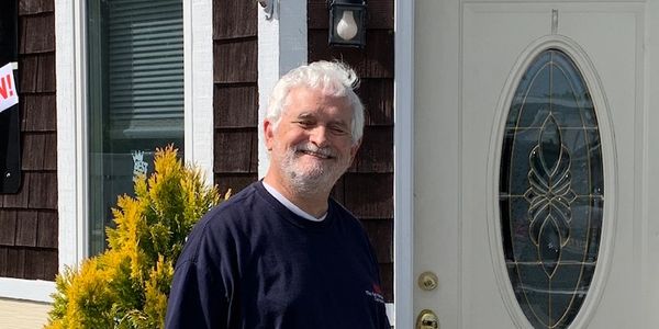 Mike by front door of his shop.