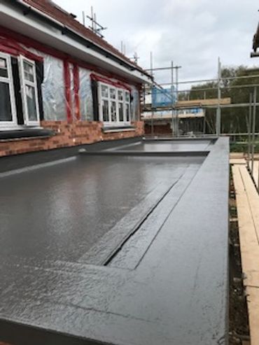 Flat roof installation on a building under construction.