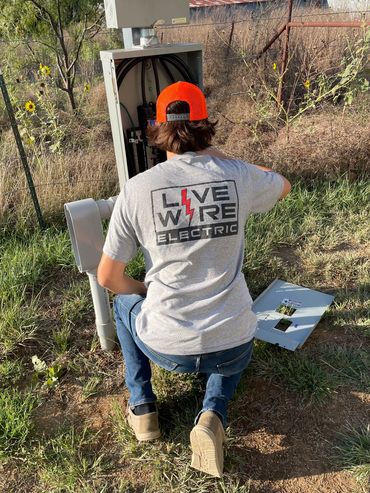 Electrician installing electrical equipment. Electrician Near Me. Electricians Weatherford, Tx.