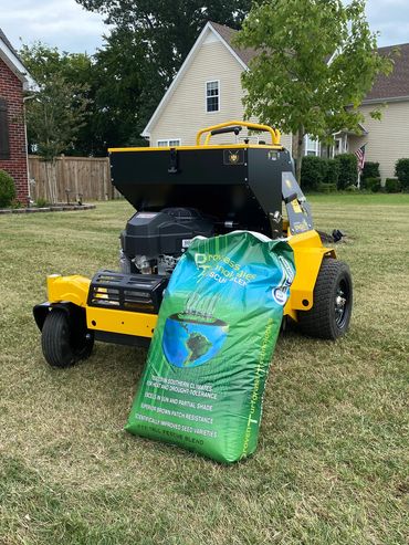 Aerator and bag of grass seed before aeration