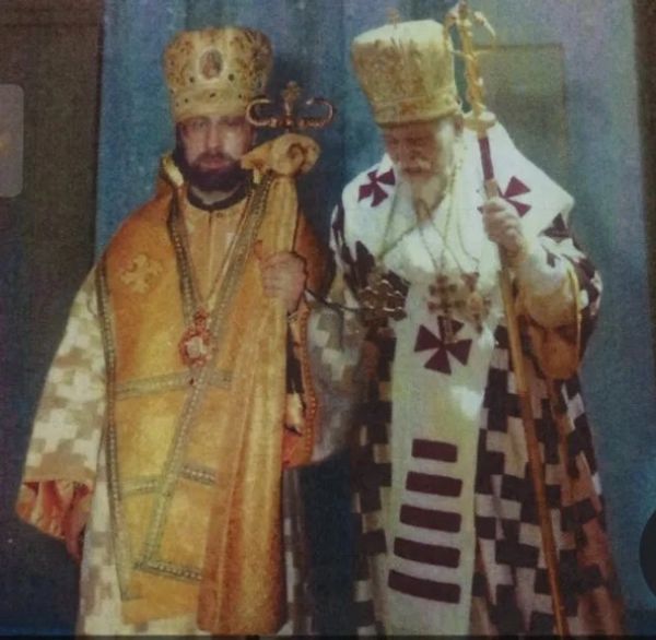 Two Orthodox Christian bishops in ceremonial robes holding staffs.