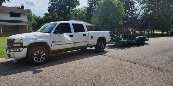 truck with mini skid loaded for a project
