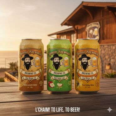 Three craft beer cans from Yidish Brewskis Brewing Co. displayed outdoors at sunset.