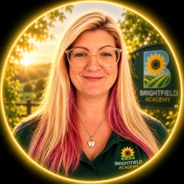 Smiling woman with glasses at Brightfield Academy.