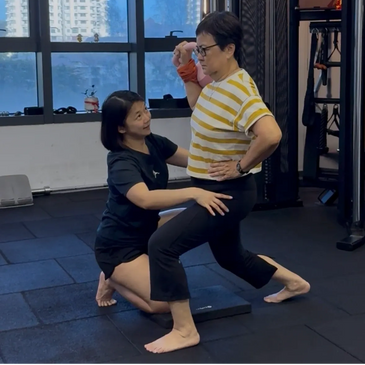 female fitness coach teaching senior grandmother how to lunge for vitality, posture & strength.