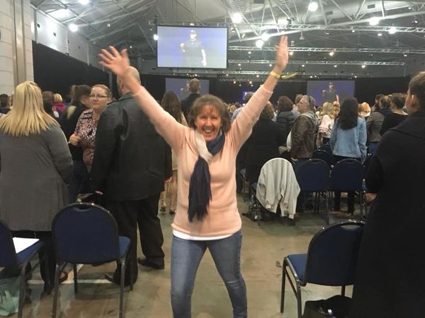 Fiona Brown reaching up with two hands