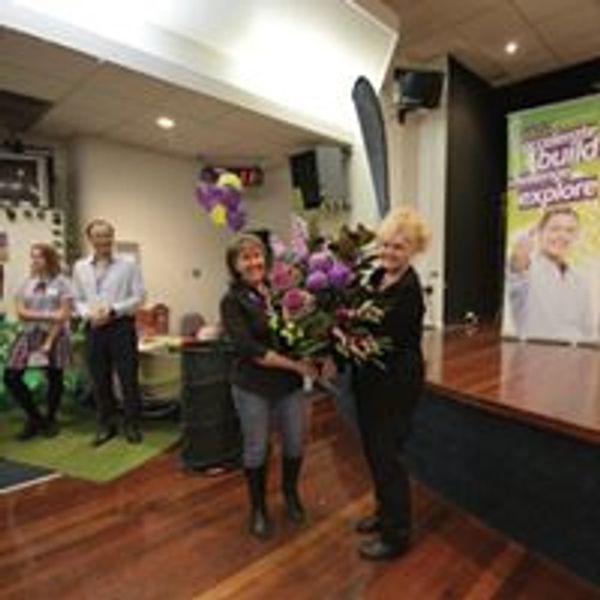 Fiona Brown receiving flowers for her work as program manager for max potential