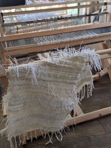 All white table runner handwoven with ostrich feathers.