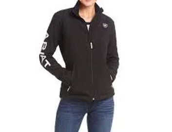 Woman wearing a black zip-up jacket with white text on the sleeve.