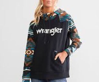 Woman wearing a black Wrangler hoodie with patterned sleeves and hood.