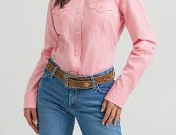 Person wearing a pink shirt and blue jeans with a brown belt.