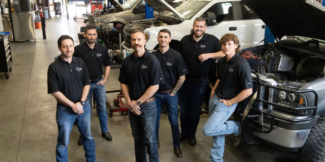 Group photo of Power Stroke Magic employees in the shop.