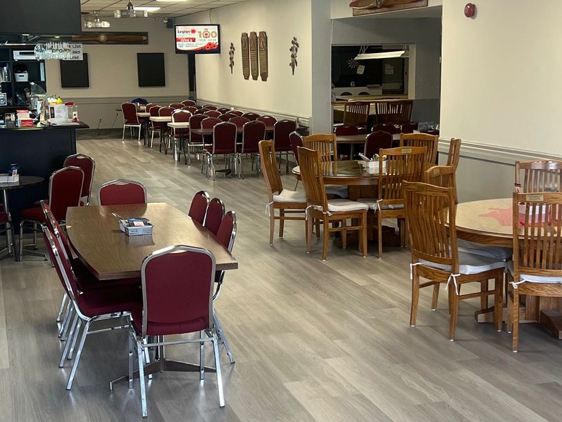 Empty dining area with mixed seating and wooden flooring.