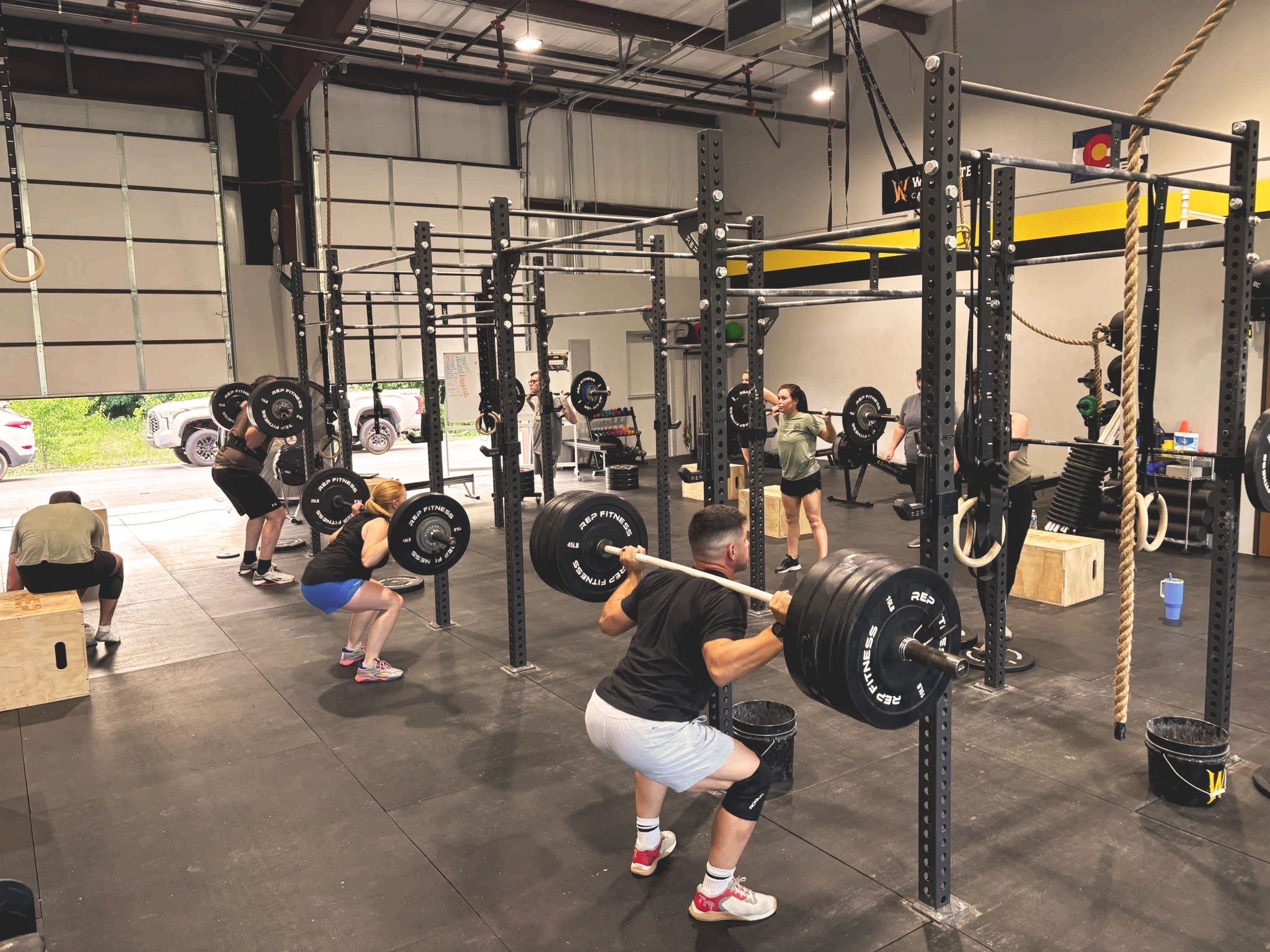 Wildcatter CrossFit members in CrossFit  group class lifting weights