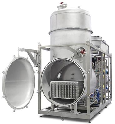 Industrial autoclave with an open door for sterilization processes.