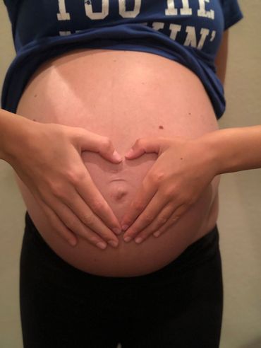 pregnant belly with hands on it