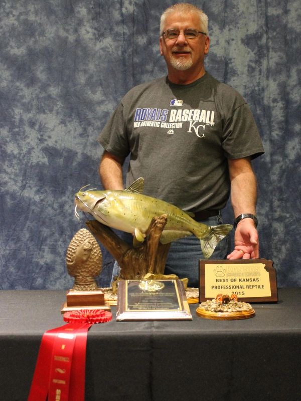 Award-winning taxidermist Tim Stidham stands by a catfish mount that won awards at a competition.