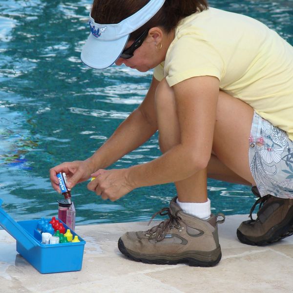 Pool technician performing water analysis