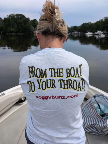 A woman sitting on the back of a boat.