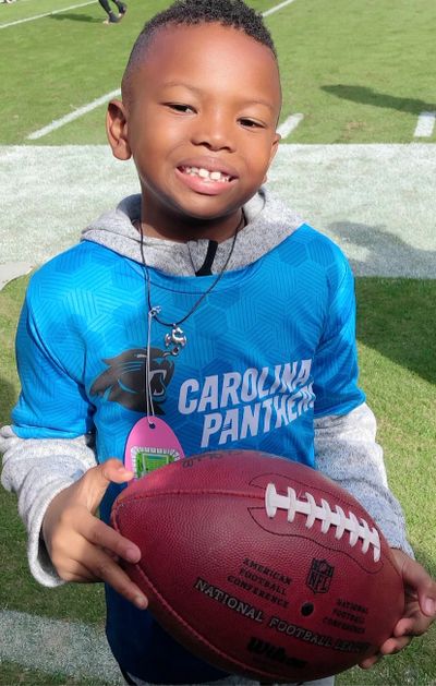 The Kid Knows Sports holding football