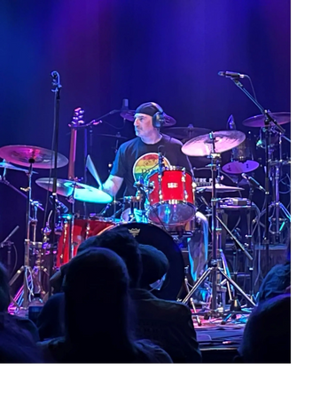 Anthony Crachiolo playing drums live on stage
