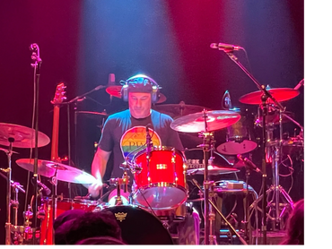 Anthony Crachiolo playing drums live on stage