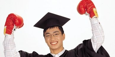 A graduate with red boxing gloves on.