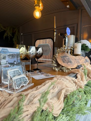 Cozy, decorated bar setup with gold glasses and greenery.