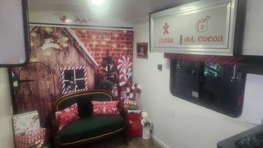 Cozy Christmas-themed room with decorations and gifts.