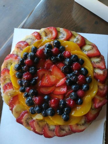 Fruit Tart----Kiwi, raspberry, blueberry, strawberry and peach with vanilla custard and pastry crust