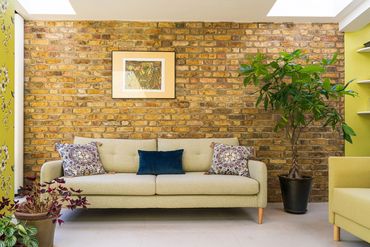 Reclaimed brickwork forms the backdrop to the new living area in the Newham extension.