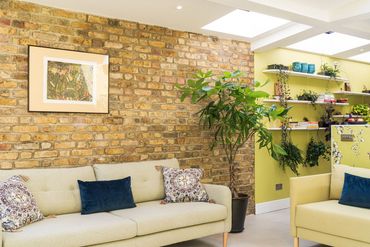 Exposed brickwork and roof glazing in the finished living area of the Newham extension.