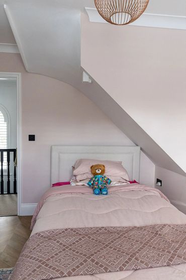 First-floor bedroom showing the new loft staircase enclosed above part of the room.
