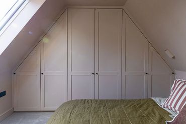Bespoke fitted wardrobes shaped to suit the sloping roof of the Brentwood loft.